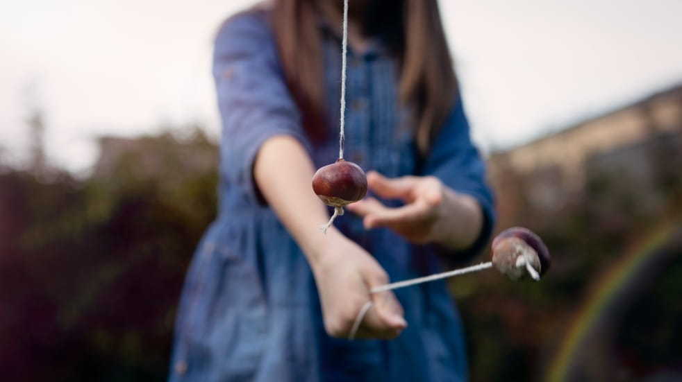 girl playing conkers
